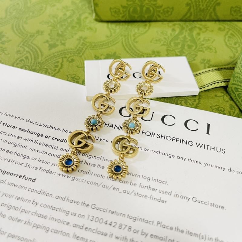 G*u*i earrings